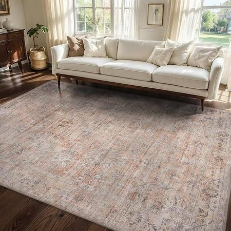 a living room filled with furniture and a large rug on top of a hard wood floor