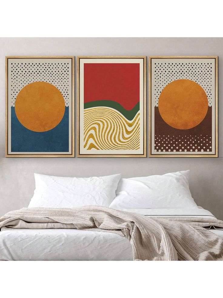 two paintings on the wall above a bed