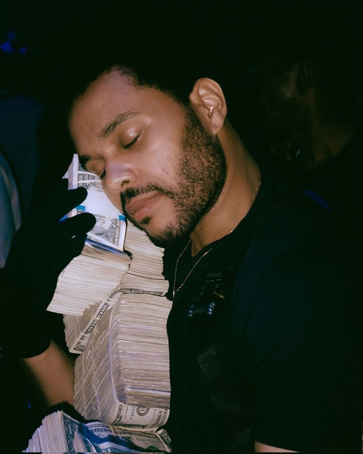 a man sleeping on top of stacks of papers