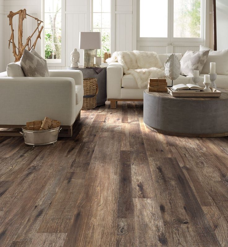 a living room with wood floors and white furniture