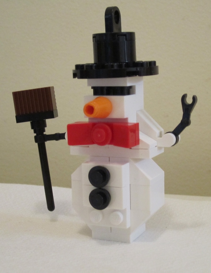 there is a lego snowman with a broom and hat on it's head