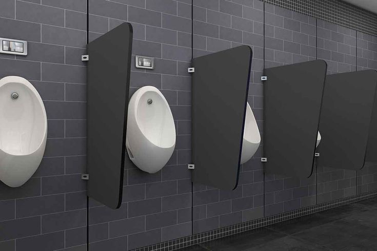 a row of urinals mounted to the side of a wall next to each other