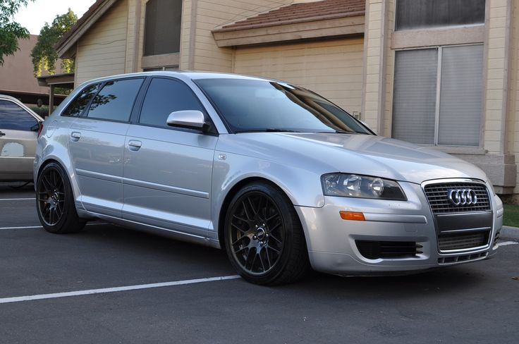 a silver car is parked in a parking lot