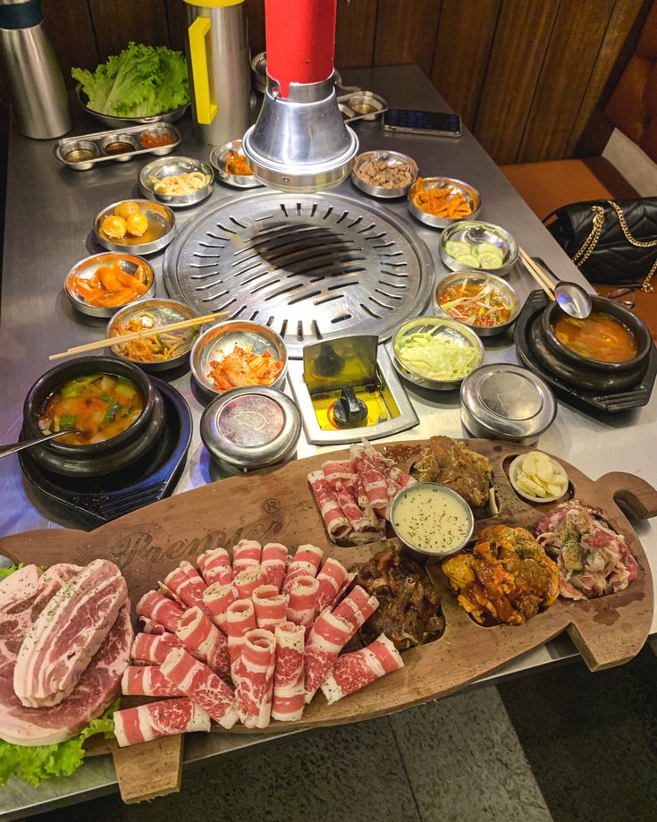 an assortment of meats and vegetables on a table