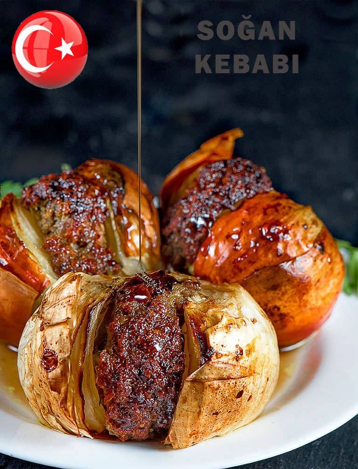 some food is on a white plate with a flag in the background and an inscription that reads sogan kebab