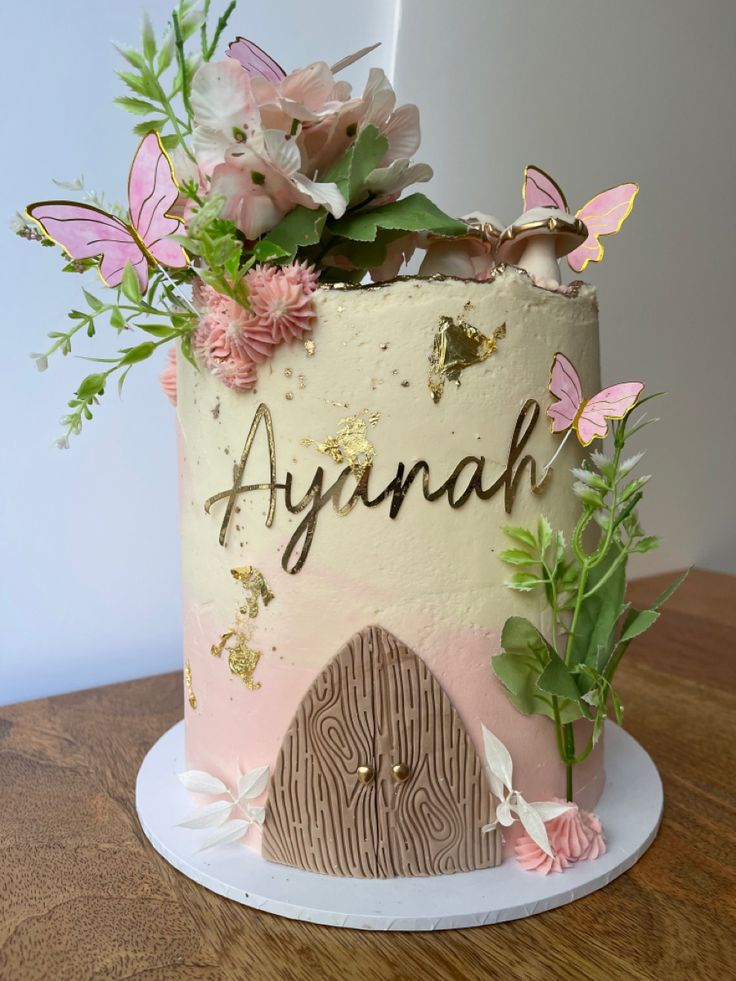 there is a cake with flowers on it and the words asynah written in cursive writing