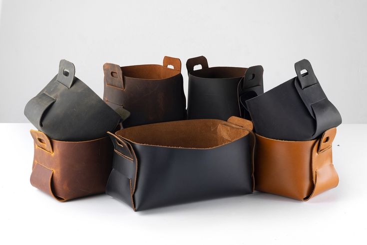 five leather bags are stacked on top of each other in different colors and sizes,