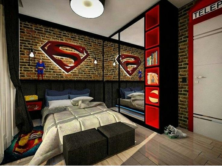 a bedroom with a bed and shelves in the corner, superman themed wallpaper on the brick wall