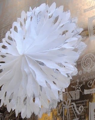 a white paper flower sitting on top of a table