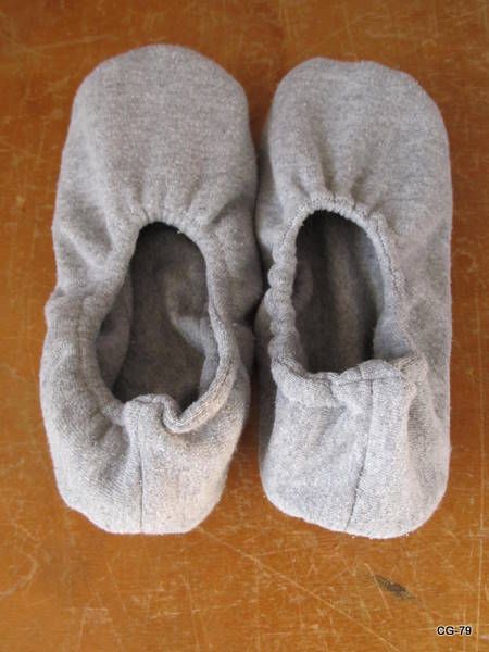 two pairs of slippers sitting on top of a wooden table