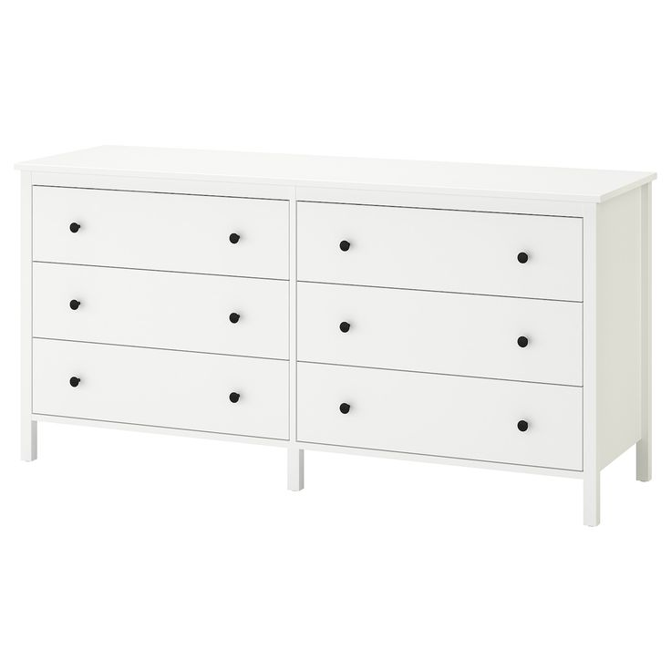 a white dresser with black knobs and drawers