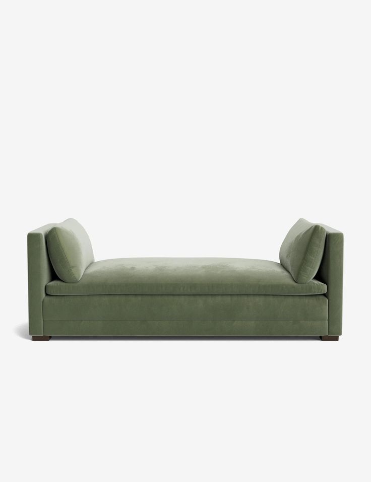 a green couch sitting on top of a white floor