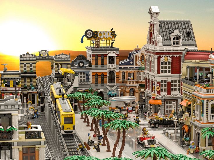 a large lego city with palm trees and people on the street at sunset or dawn