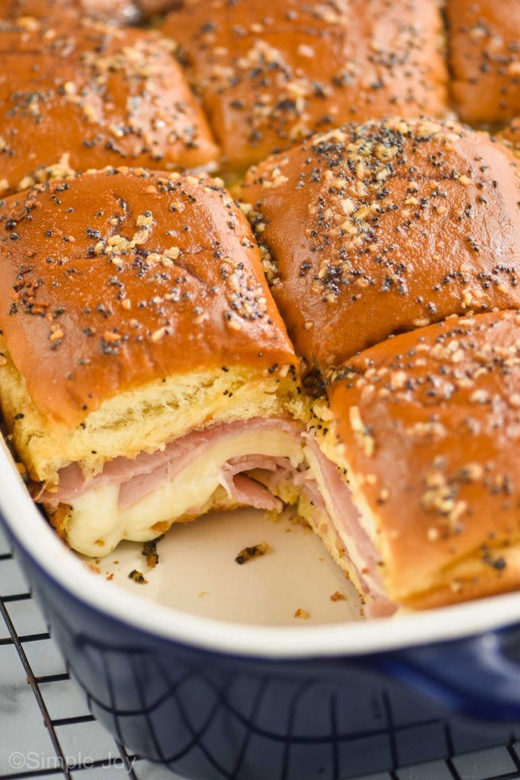 ham and cheese sliders in a blue casserole dish