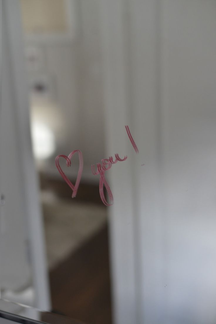 i love you written on the glass in front of a refrigerator freezer and door