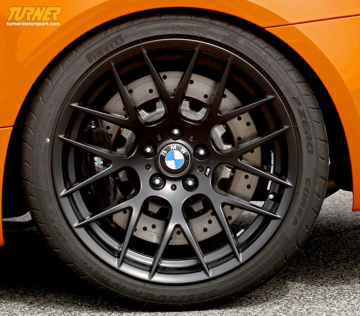 the front wheel of an orange sports car