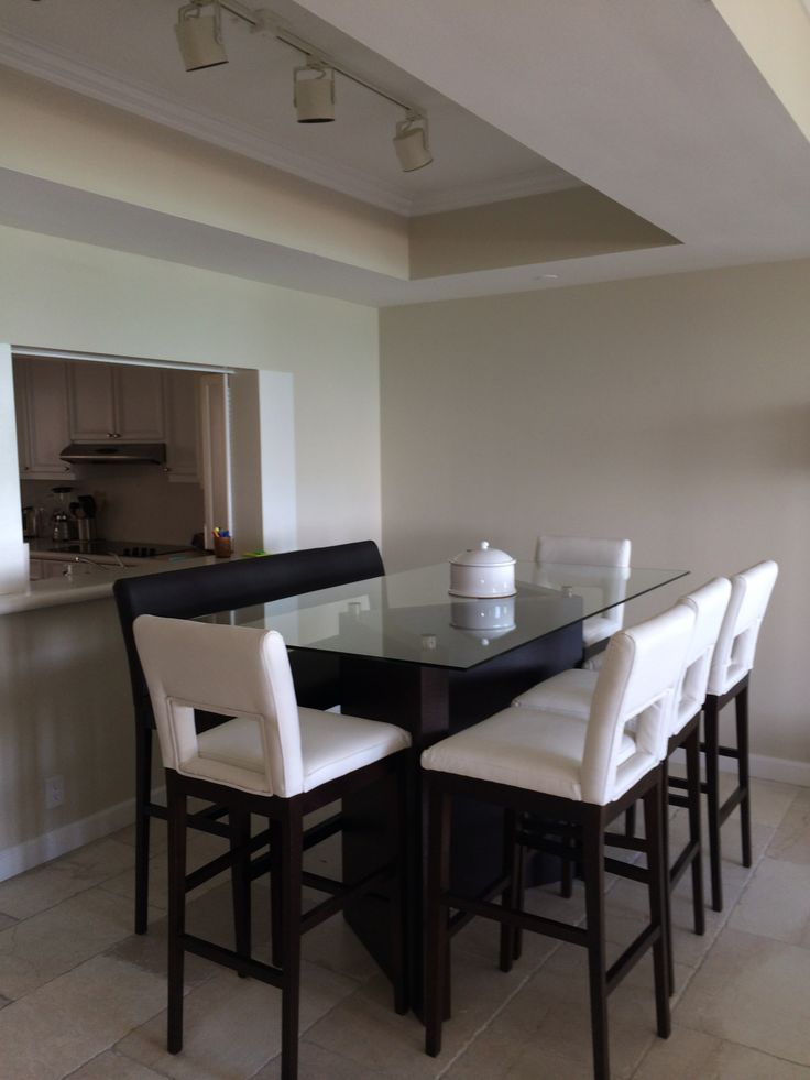 a dining room table with white chairs around it