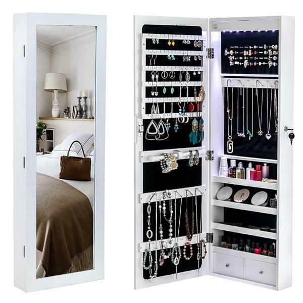 an open mirrored closet with jewelry hanging on the door and mirror in front of it