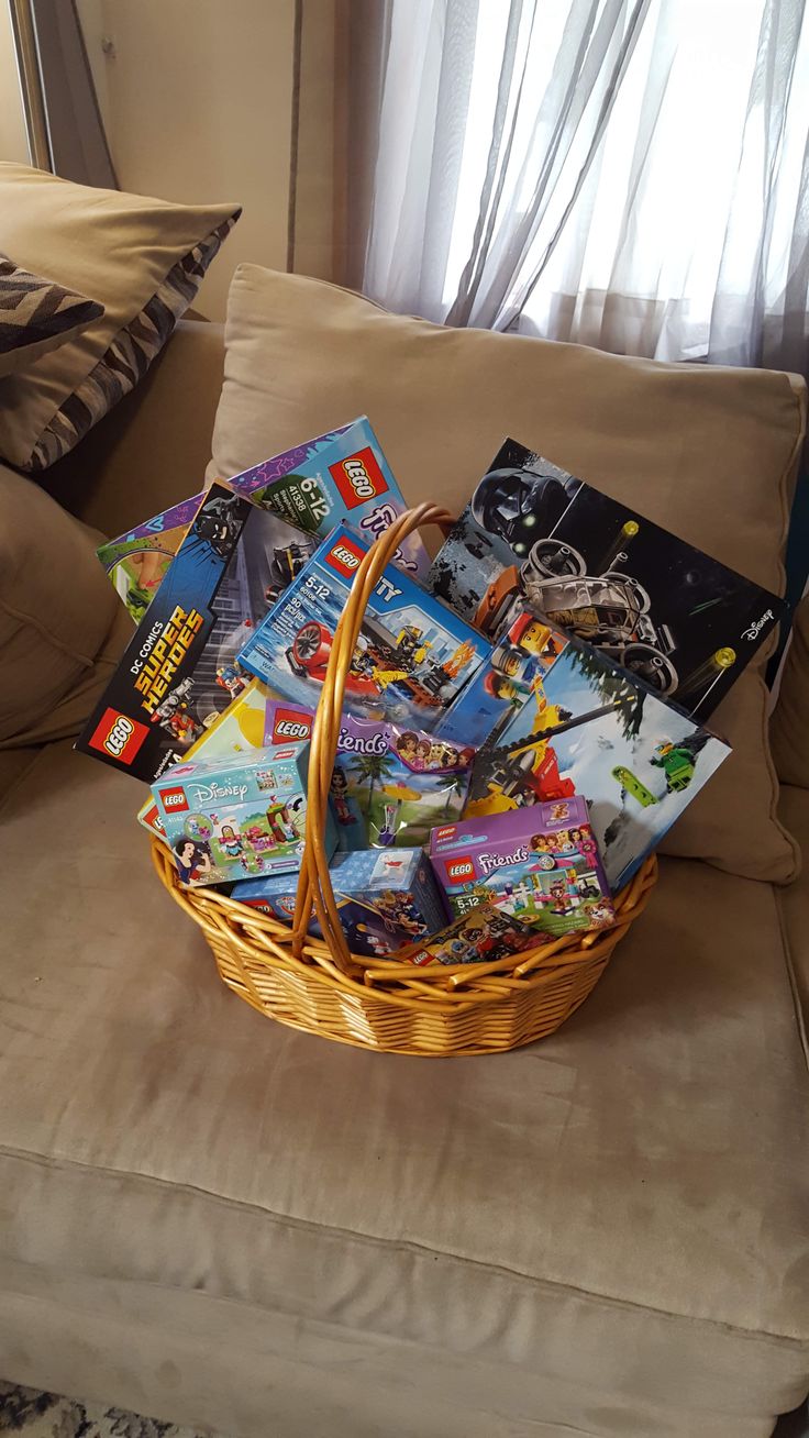 a basket filled with books sitting on top of a couch