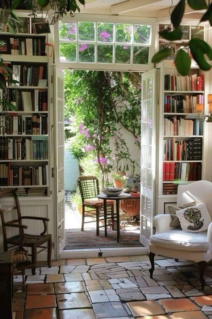 a living room filled with lots of furniture and bookshelves next to a doorway