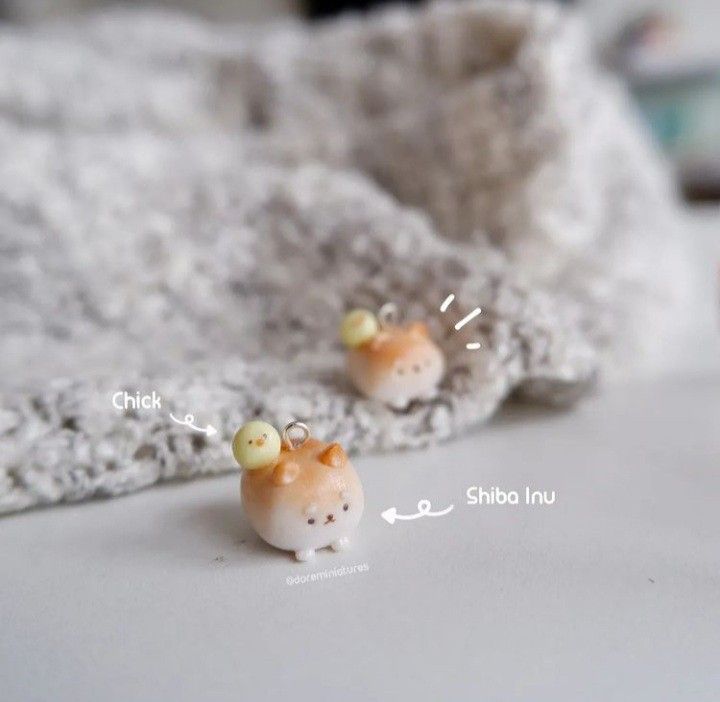 two tiny orange and white animals sitting on top of a bed next to each other