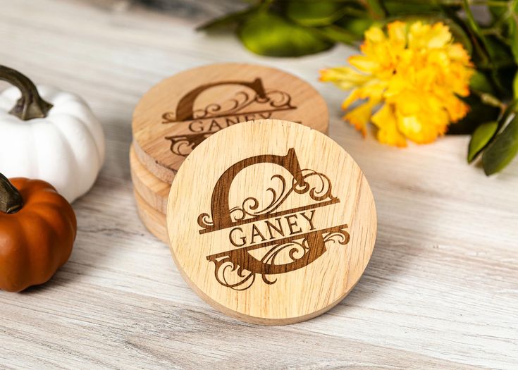 personalized wooden coasters with the letter g on them next to pumpkins and flowers