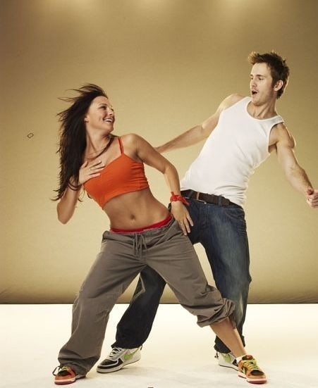 two people are dancing together in the studio