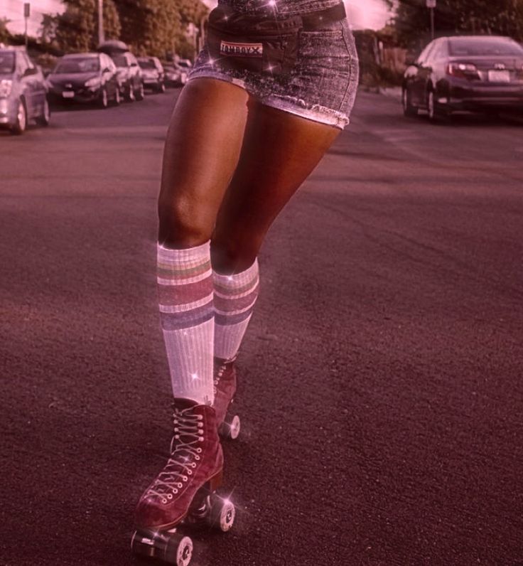 a woman riding roller skates down a street