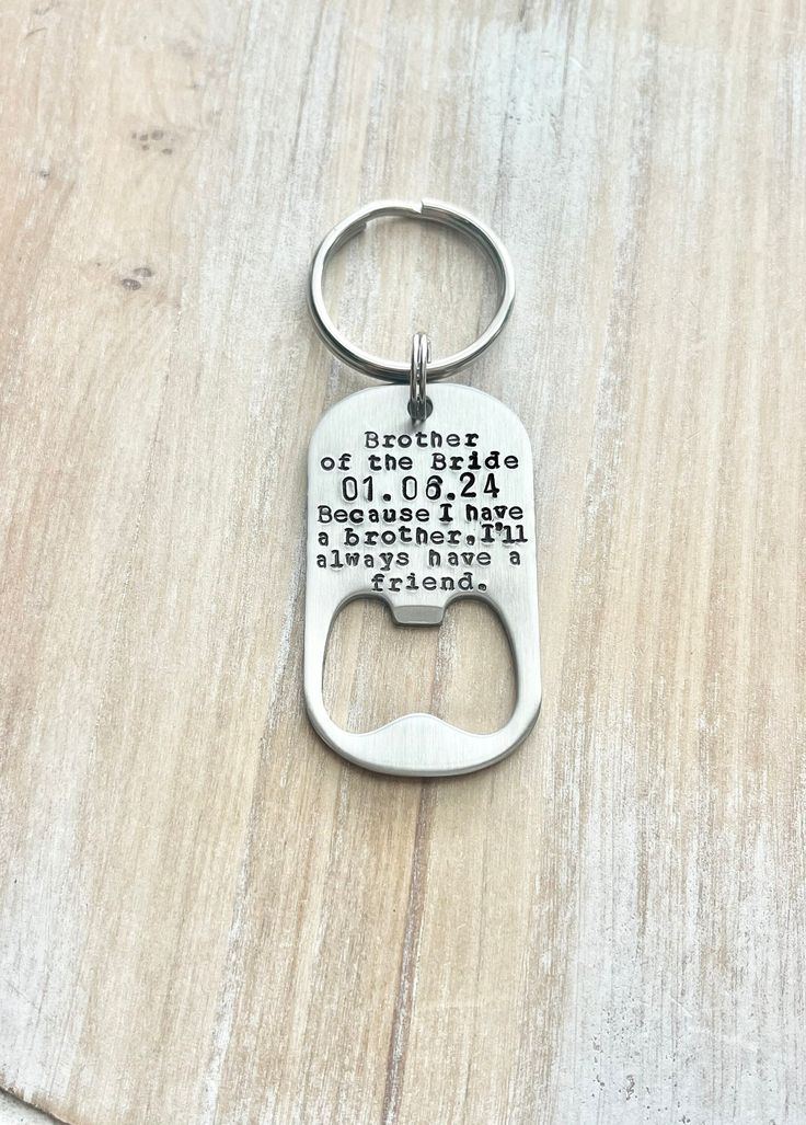 a bottle opener keychain with the words kitchen rules printed on it