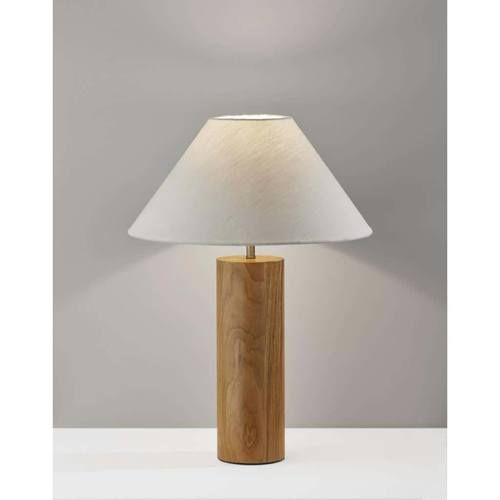 a wooden table lamp with a white shade on the base and a light grey wall behind it