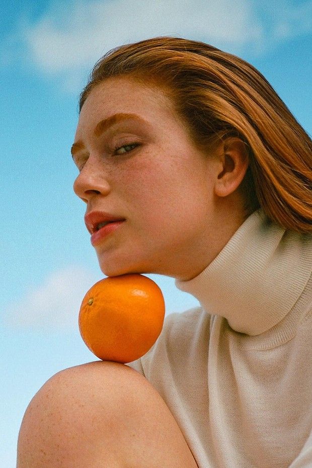 a woman with an orange on her neck