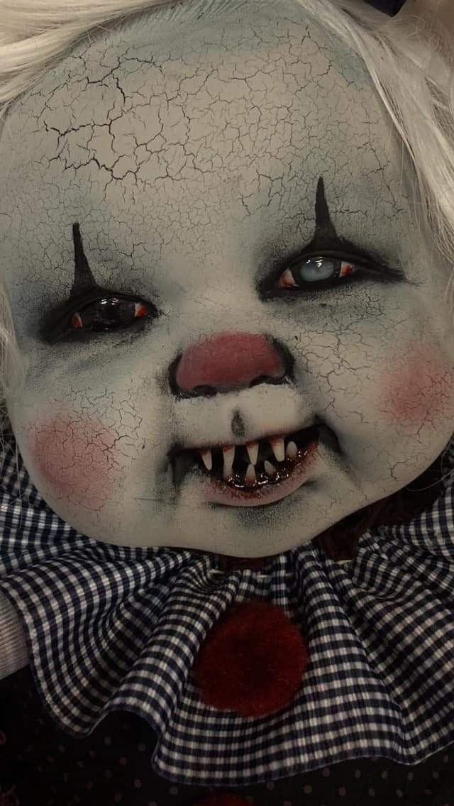 a creepy clown with white hair and black eyes