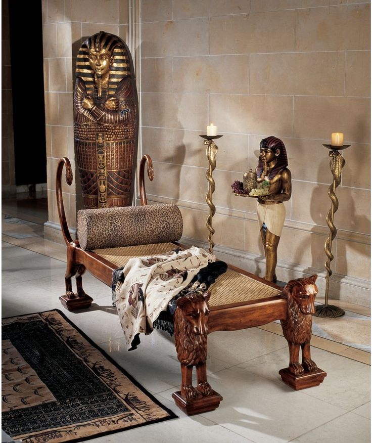 an egyptian themed bedroom with candles and furniture