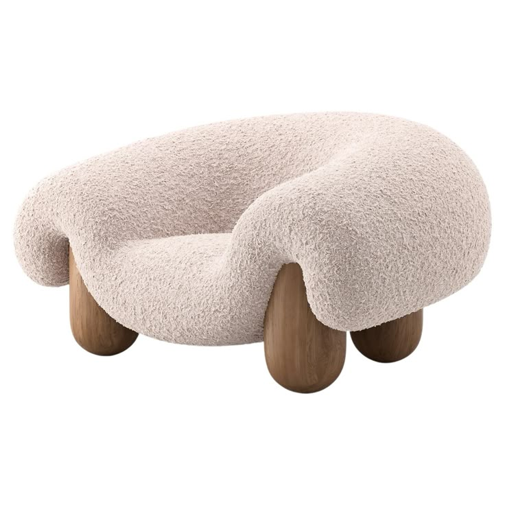 a white chair with wooden legs and an oval shaped cushion on the seat, it's made out of sheep fur