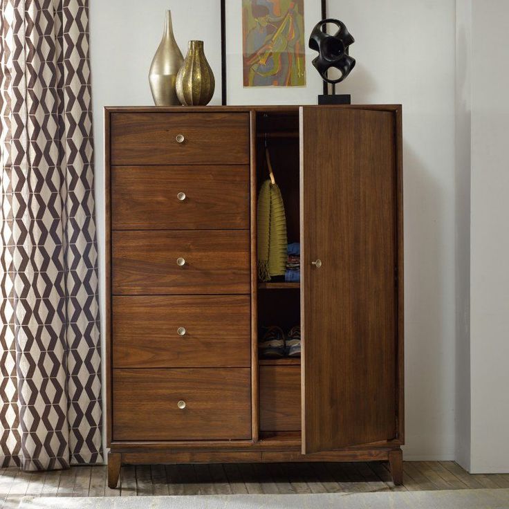 a wooden cabinet with two vases sitting on top of it