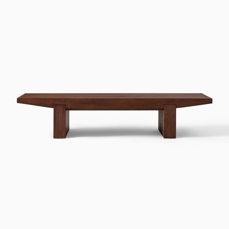 a wooden bench sitting on top of a white floor