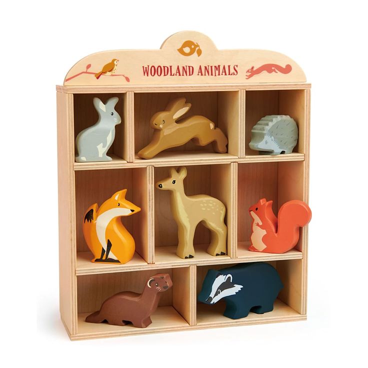 the wooden toy animals are arranged in a cubby box, with different colors and sizes