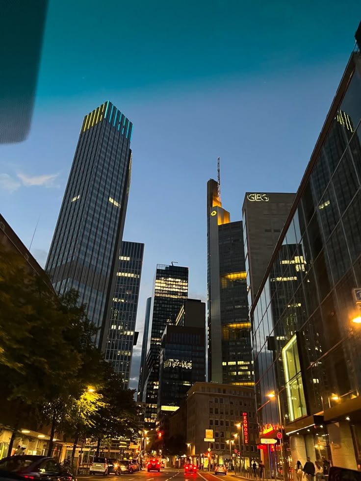 the city is lit up at night with skyscrapers in the background