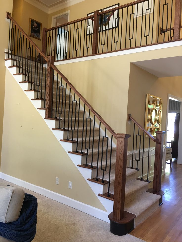 a living room filled with furniture and a stair case