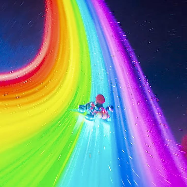 a person riding a snowboard down a rainbow colored slope