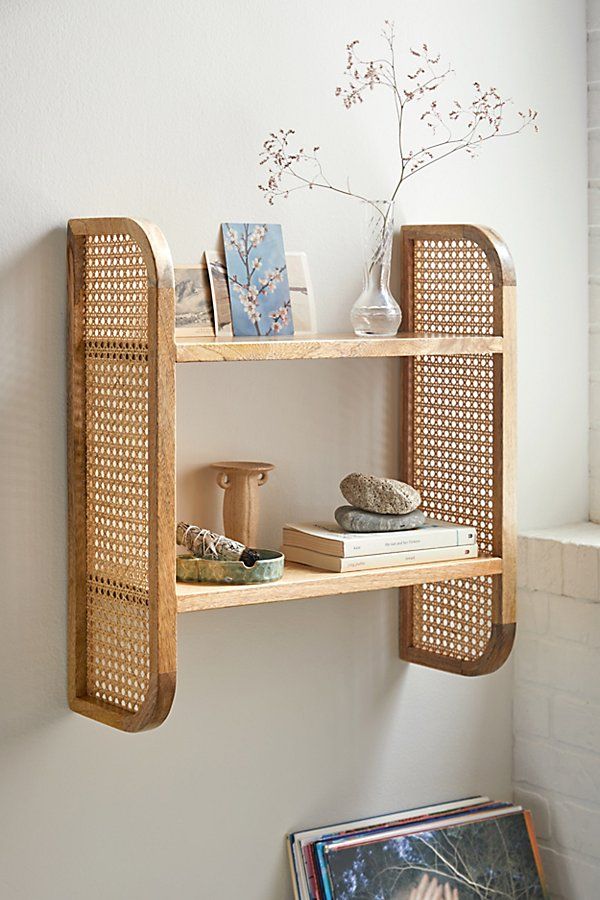 a wooden shelf with books and pictures on it