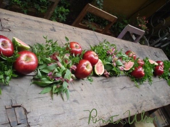 an arrangement of fruits and vegetables laid out on a table