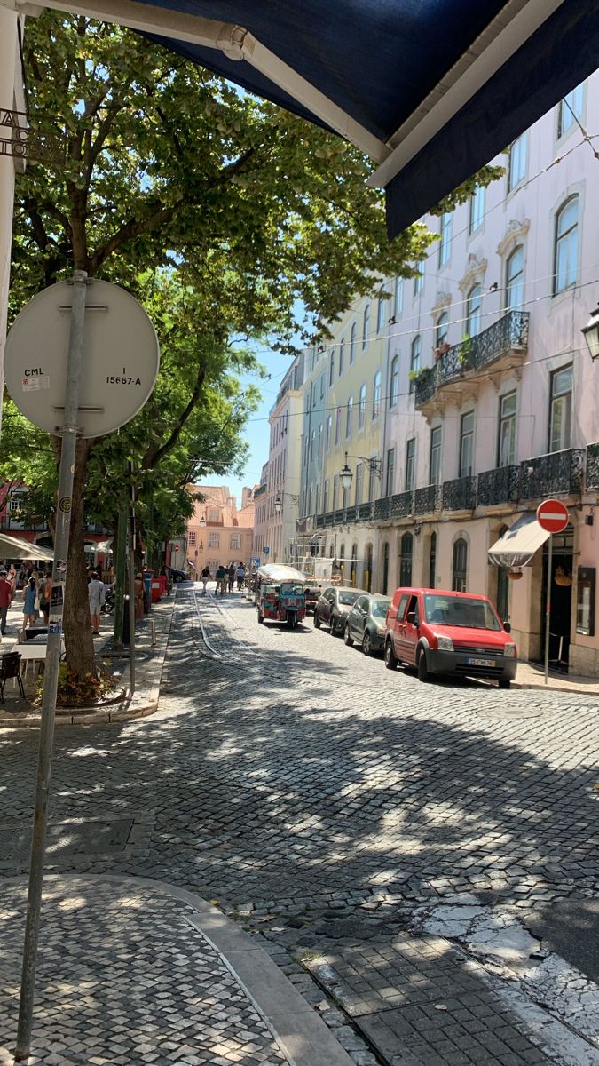 an empty street with cars parked on the side