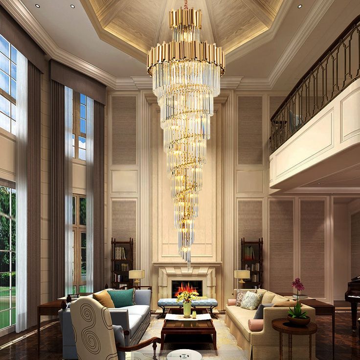 a living room with couches, chairs and a chandelier hanging from the ceiling