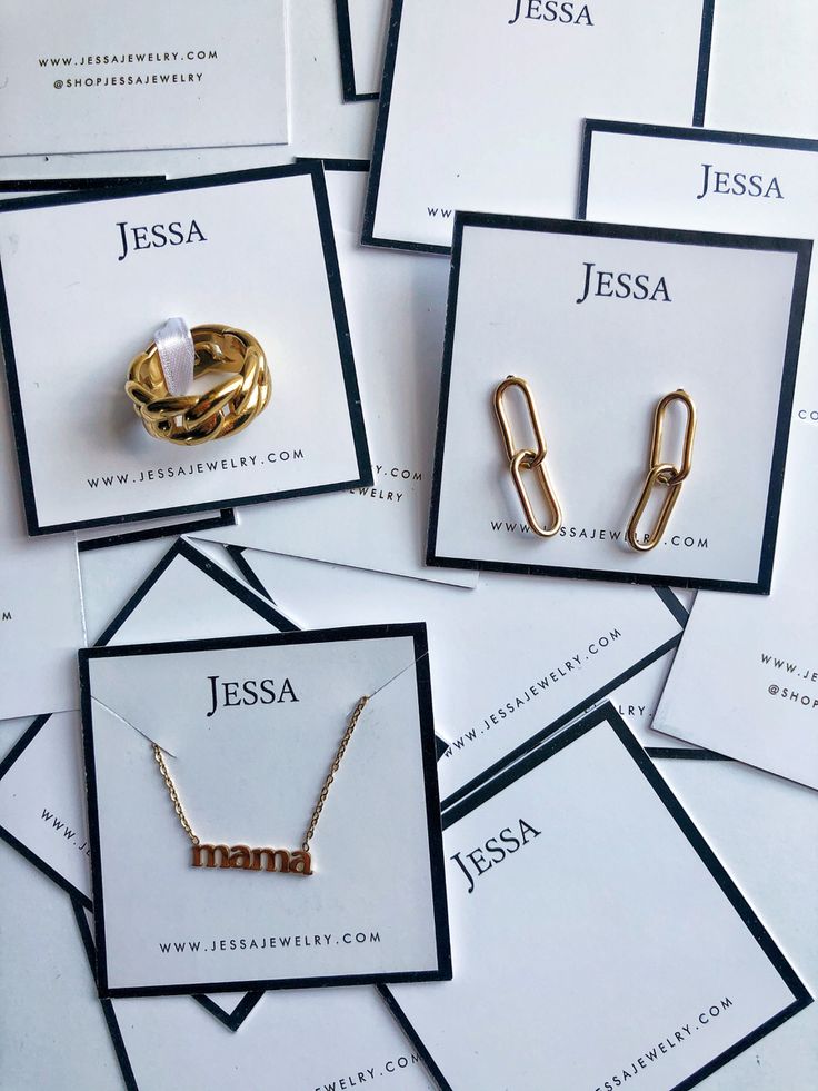 several different types of personalized jewelry are displayed on white cards with black and gold lettering