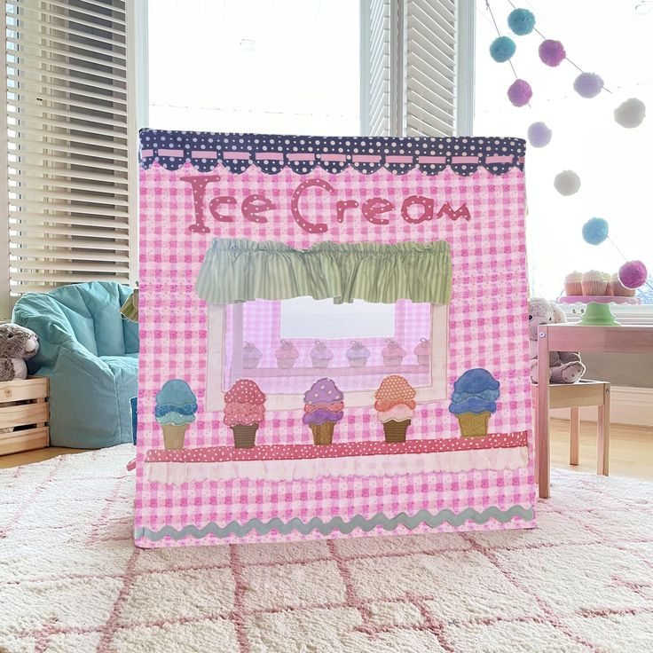 a child's play tent with cupcakes and ice cream on the window sill