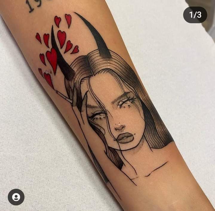 a woman with horns and hearts on her arm