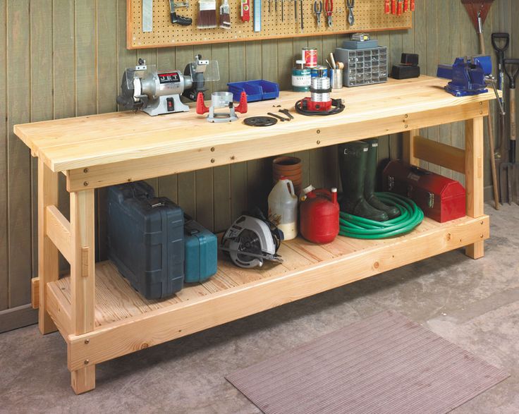 a workbench with various tools on it in a garage or repair shop area