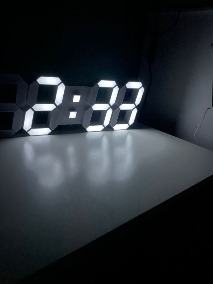 a digital clock sitting on top of a table