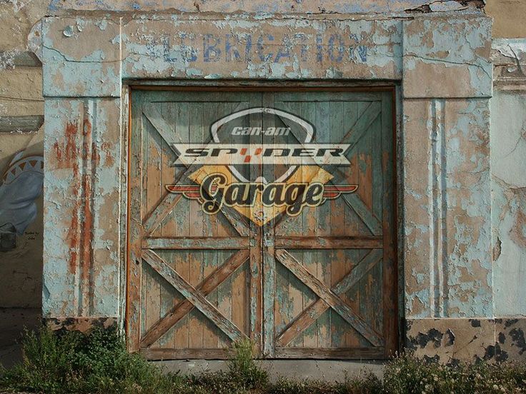 an old garage door with the words super garage painted on it's front and side